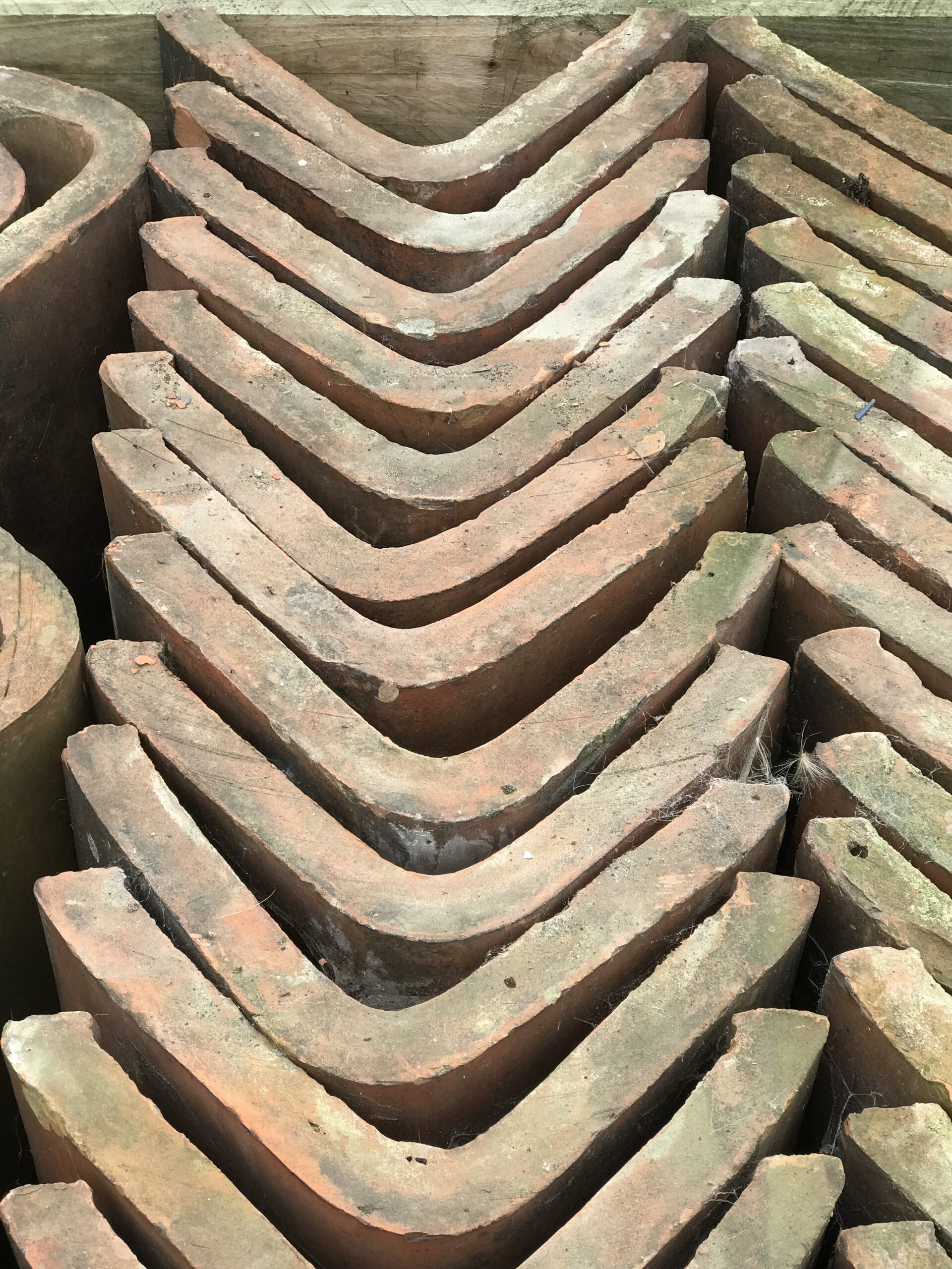 Traditional reclaimed roofing tiles stacked in a yard