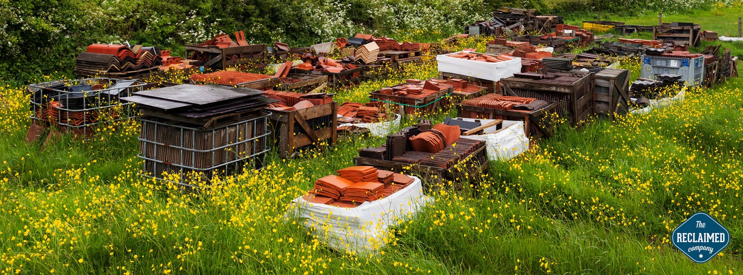 Reclaimed roofing and architectural salvage materials displayed in The Reclaimed Company yard