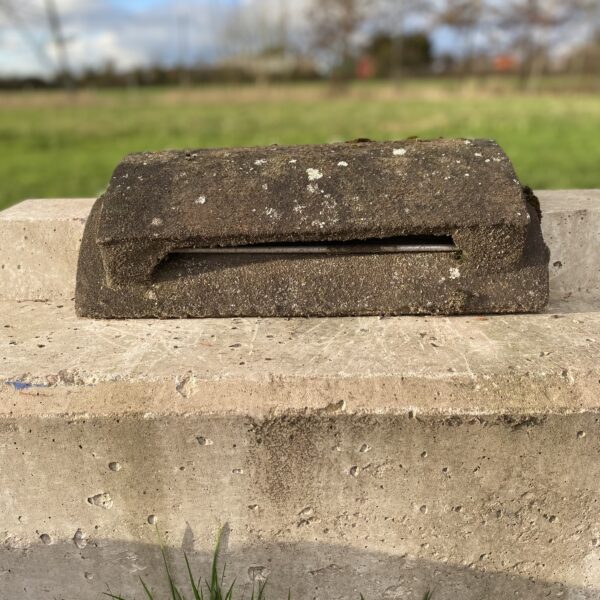 Reclaimed half round concrete vent ridge tile.