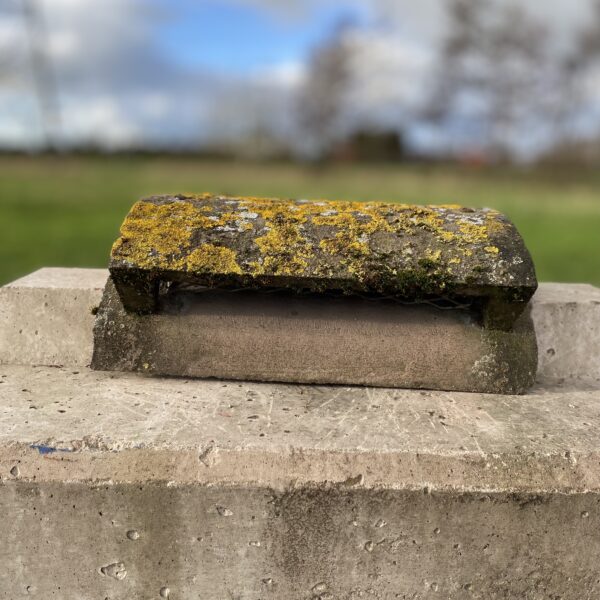 Reclaimed half round concrete vent ridge tile.