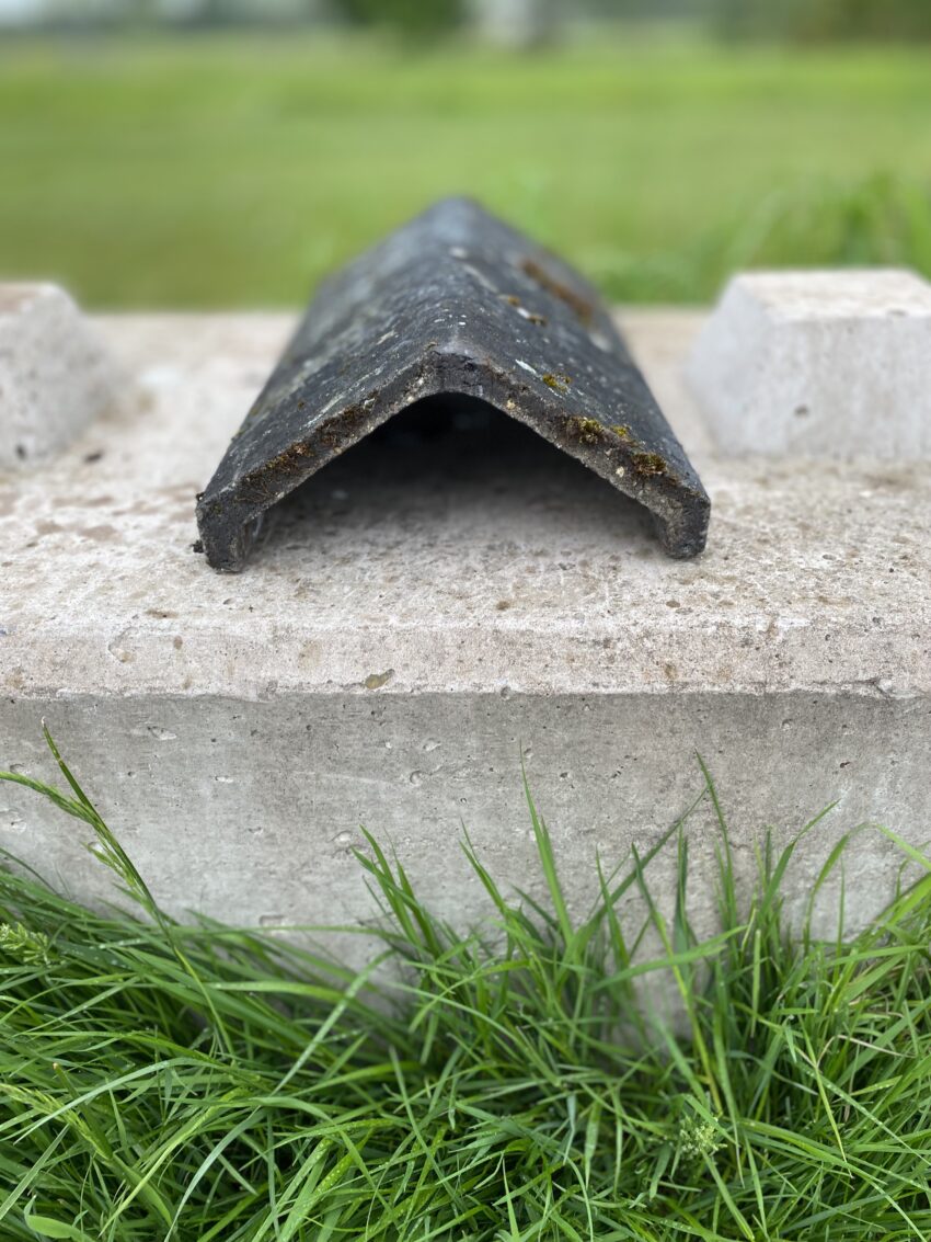 Reclaimed Black Concrete Stepped Angled Ridge Tile.