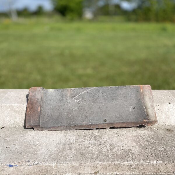 Reclaimed red terracotta angle capped ridge tile with traditional angular profile